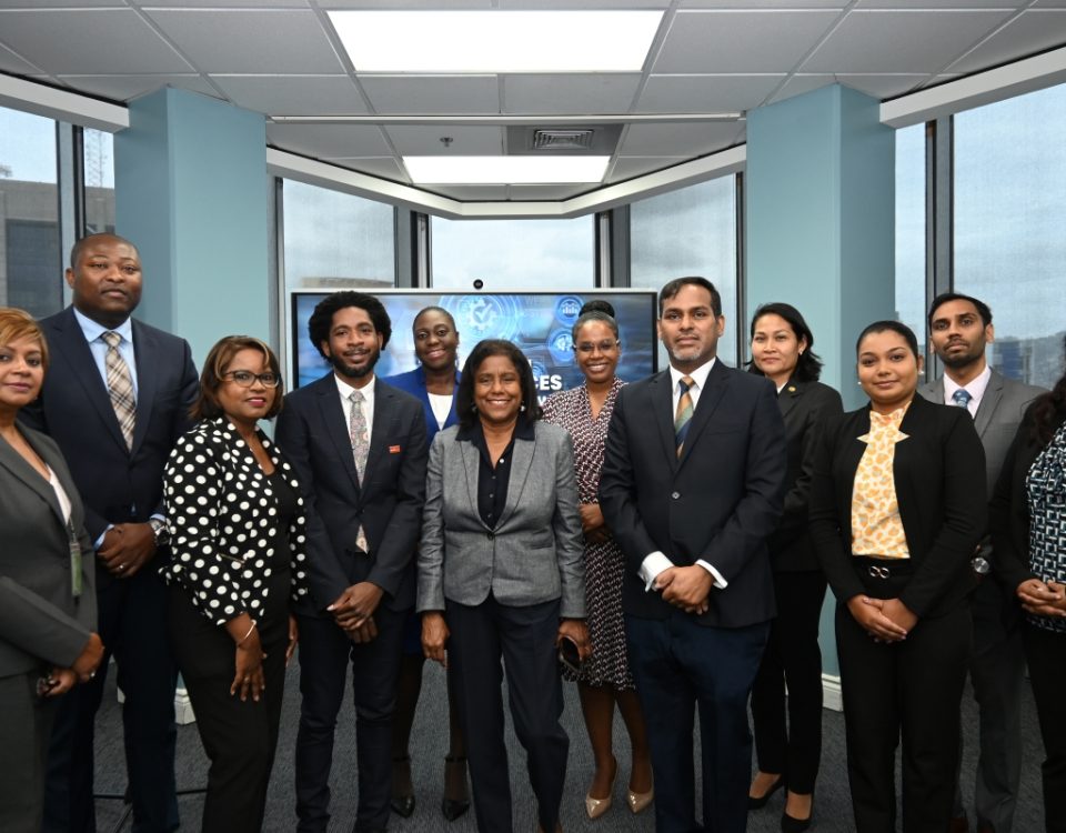 Senator the Honourable Paula Gopee-Scoon, Minister of Trade and Industry, at center, accompanied by Permanent Secretary in the Ministry of Trade and Industry Randall Karim (right), Permanent Secretary in the Ministry of Digital Transformation, Cory Belfon (second from left), and representatives of Crimson Logic, Trinidad Tourism Limited, and the Trade Licence and TTBizLink units of the Ministry of Trade and Industry.