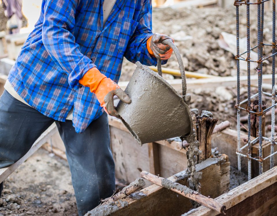 worker mixing cement mortar plaster for construction